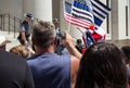 Conservative Demonstrators Hold Up Thin Blue Line Flags as Police Officers Deal with Counter-Protestor