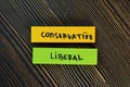 Conservative and Liberal write on sticky notes isolated on Wooden Table Royalty Free Stock Photo