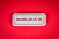 Consideration Concept. Paper sticker with text on a red background