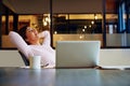 Considering her options...a businesswoman leaning back in her chair with her hands behind her head. Royalty Free Stock Photo