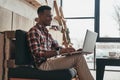 Considering the next step. Handsome young man using laptop and s Royalty Free Stock Photo