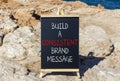 Consistent brand message symbol. Concept words build a consistent brand message on beautiful black chalkboard. Beautiful stone sea