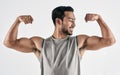 Consistent hard work gains success. Studio shot of a muscular young man flexing his biceps against a white background. Royalty Free Stock Photo
