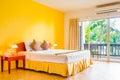 Interior decoration of romantic plain yellow bedroom with balcony Royalty Free Stock Photo