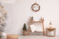 Console table with Christmas decoration near wall. Idea for festive interior