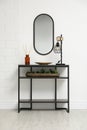 Console table with decor near mirror in room. Interior design Royalty Free Stock Photo