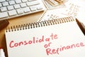 Consolidate or refinance handwritten in a notepad. Royalty Free Stock Photo
