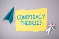 CONSPIRACY THEORIES. Text on note sheet, paper plane, symbol of gaining goals