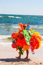 CONSTANTA, ROMANIA - AUGUST 21, 2010. toys seller walking on the beach by the sea