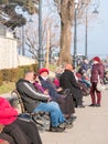 Constanta, Romania - 02.25.2021: Seniors sitting on the benches located on the seafront Faleza Casino in Constanta