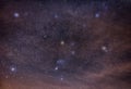 Orion with its cosmic neighbors in the clouds