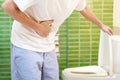 Constipation and diarrhea in bathroom. Hurt man touch belly stomach ache painful. colon inflammation problem, toxic food,