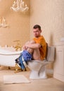 Constipation problem, man sitting on toilet bowl Royalty Free Stock Photo