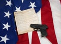 Constitution with Hand Gun on American Flag Royalty Free Stock Photo