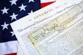 Constitution of the USA with US flag. Aged historical documents Royalty Free Stock Photo