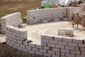 Constraction workers building a roundhouse with aerated autoclaved concrete blocks. Royalty Free Stock Photo