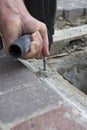 Construc worker fixing the pavestone on the roadtion worker installing stone blocks on pavement Royalty Free Stock Photo