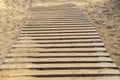 Constructed wooden walkpath in the sand at daytime