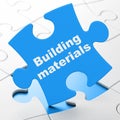 Constructing concept: Building Materials on puzzle background