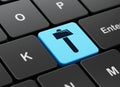 Constructing concept: Hammer on computer keyboard background Royalty Free Stock Photo