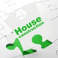 Constructing concept: House Construction on puzzle background