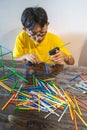 Constructing with lots of colorful plastic sticks. fun with building geometric figures and learning mathematics at home. Royalty Free Stock Photo