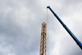 Constructing process of a tower crain. yellow steel truss erected by a mobile crane Royalty Free Stock Photo