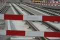 Constructing of street-car line, embedding of metal rails in a concrete base with a barrier planks in the foreground