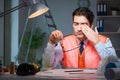 The construction architect working on drawings late at night Royalty Free Stock Photo