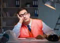 Construction architect working on drawings late at night Royalty Free Stock Photo