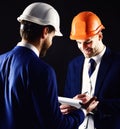 Construction, architecture, work, job concept. Engineers with smiling faces discuss project. Businessman and happy