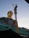 The construction of the biggest golden buddha statue head part in the temple