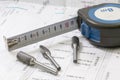 Construction blueprints with tools and measuring tape, roulette, closeup. With place for rext Royalty Free Stock Photo