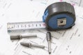 Construction blueprints with tools and measuring tape, roulette, closeup. With place for rext Royalty Free Stock Photo