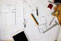 Construction blueprints with tools and tablet, top view. Tablet with architectural blueprints and measuring tools on wooden table Royalty Free Stock Photo