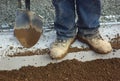 Construction boots shovel digging man working close-up on work clothes Royalty Free Stock Photo