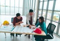 Construction Boss business man engineer and architect is discussing on working table with building plan