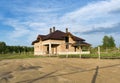 Construction of brick family house in suburbs. Shell of town home with completed walls and roof. Building a home in the field Royalty Free Stock Photo