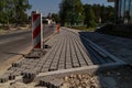 Construction of brick paved sidewalk, half built pavement road