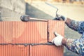 Construction bricklayer worker building walls with bricks and mortar Royalty Free Stock Photo