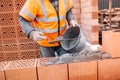 Construction bricklayer worker building walls with bricks, mortar and putty knife Royalty Free Stock Photo