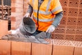 Construction bricklayer worker building walls with bricks, mortar and putty knife Royalty Free Stock Photo