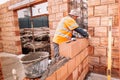 Construction bricklayer worker building walls with bricks, mortar and putty knife Royalty Free Stock Photo