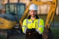 Construction build man with excavator at industrial site. Worker in helmet with bulldozer. Engineer work with builder Royalty Free Stock Photo
