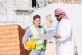 Construction builder working with Arab man project manager real estate investor for new building Royalty Free Stock Photo
