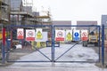 Construction building site entrance gate fence and health and safety signs Royalty Free Stock Photo