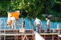 Construction building workers at construction site pouring concrete in form Royalty Free Stock Photo