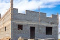 Construction of buildings from cinder block. Construction site of a two-story country house made of gray large blocks of bricks Royalty Free Stock Photo