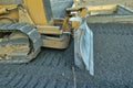 A construction bulldozer moving gravel