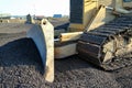 A construction bulldozer moving gravel